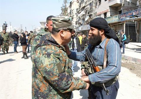NDF member (left) being embraced by a rebel fighter (right) in Babila, Damascus, after a ceasefire (February 2014)