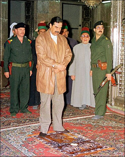 Saddam Hussein prays at a mosque in Samarra, March 12, 1998 (AP Photo)