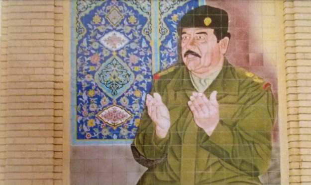 Mural of Saddam Hussein at prayer on Al-Kadhimiya Mosque
