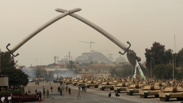 Iraqi army MIA1 Abrams tanks march under the victory Arch landmark during a parade to mark the 91st Army Day in Baghdad on January 6, 2012, weeks after US troops completed their pullout. The Armed Forces Day display by the fledgling 280,000-strong security force completely reformed after the US-led invasion of 2003. AFP PHOTO/ALI AL-SAADI (Photo credit should read ALI AL-SAADI/AFP/Getty Images)